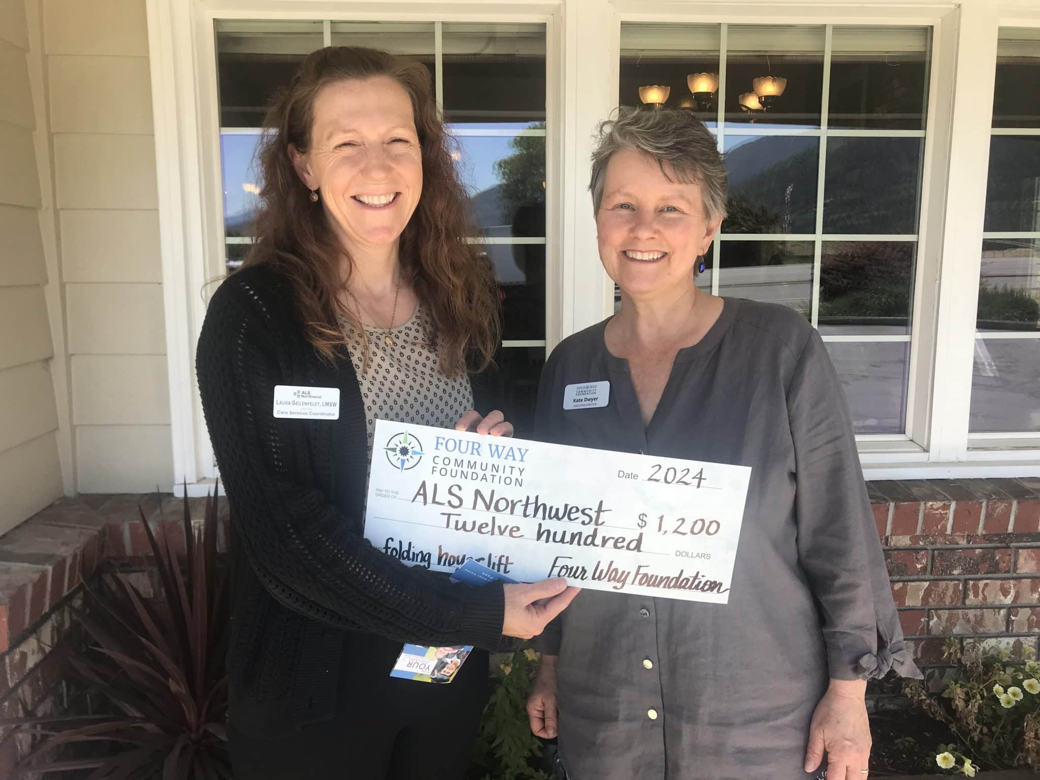 ALS Northwest staff member accepting a grant check.