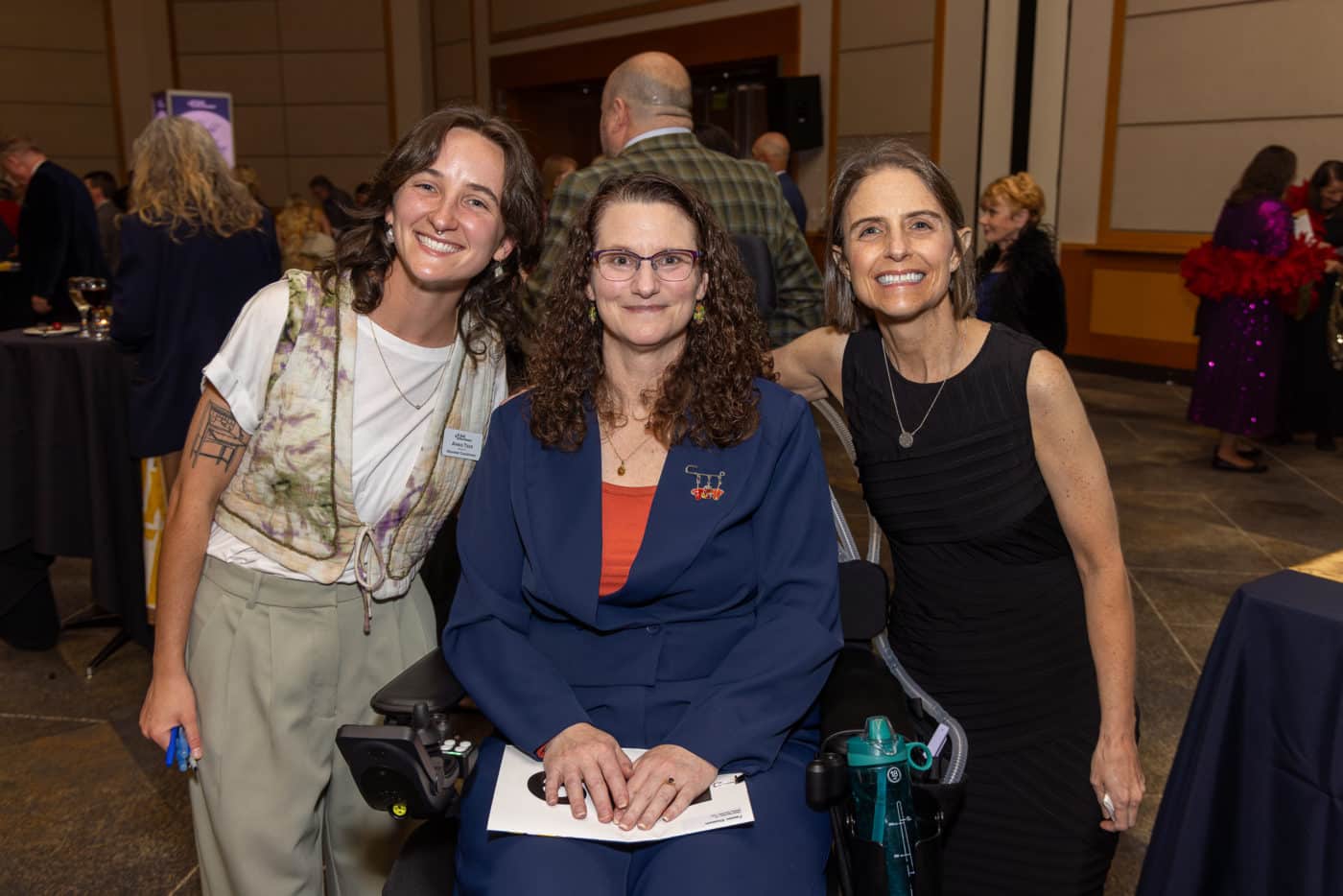 A person living with ALS with two ALS Northwest staff members