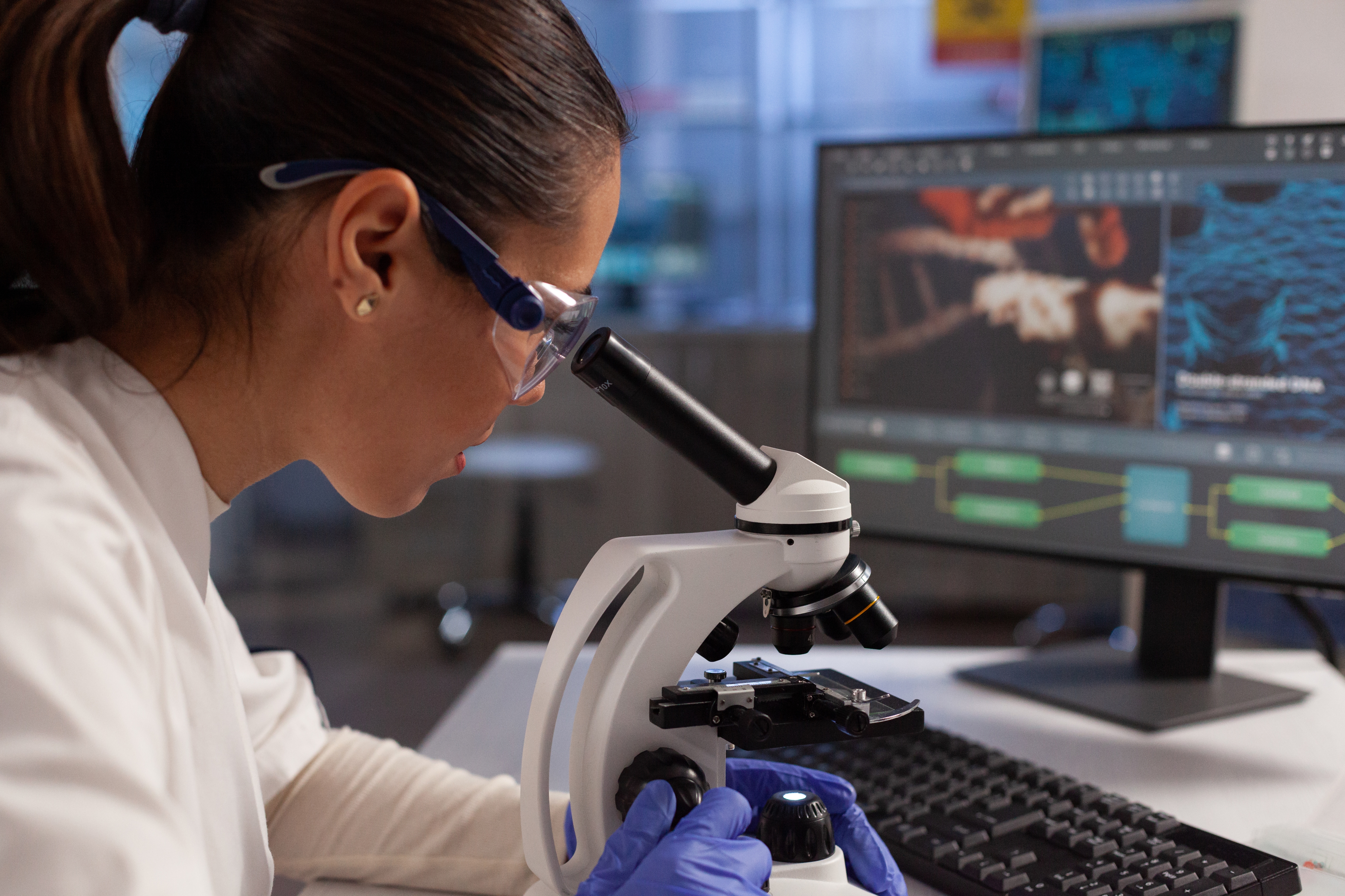 A person analyzing a tissue sample in a lab.