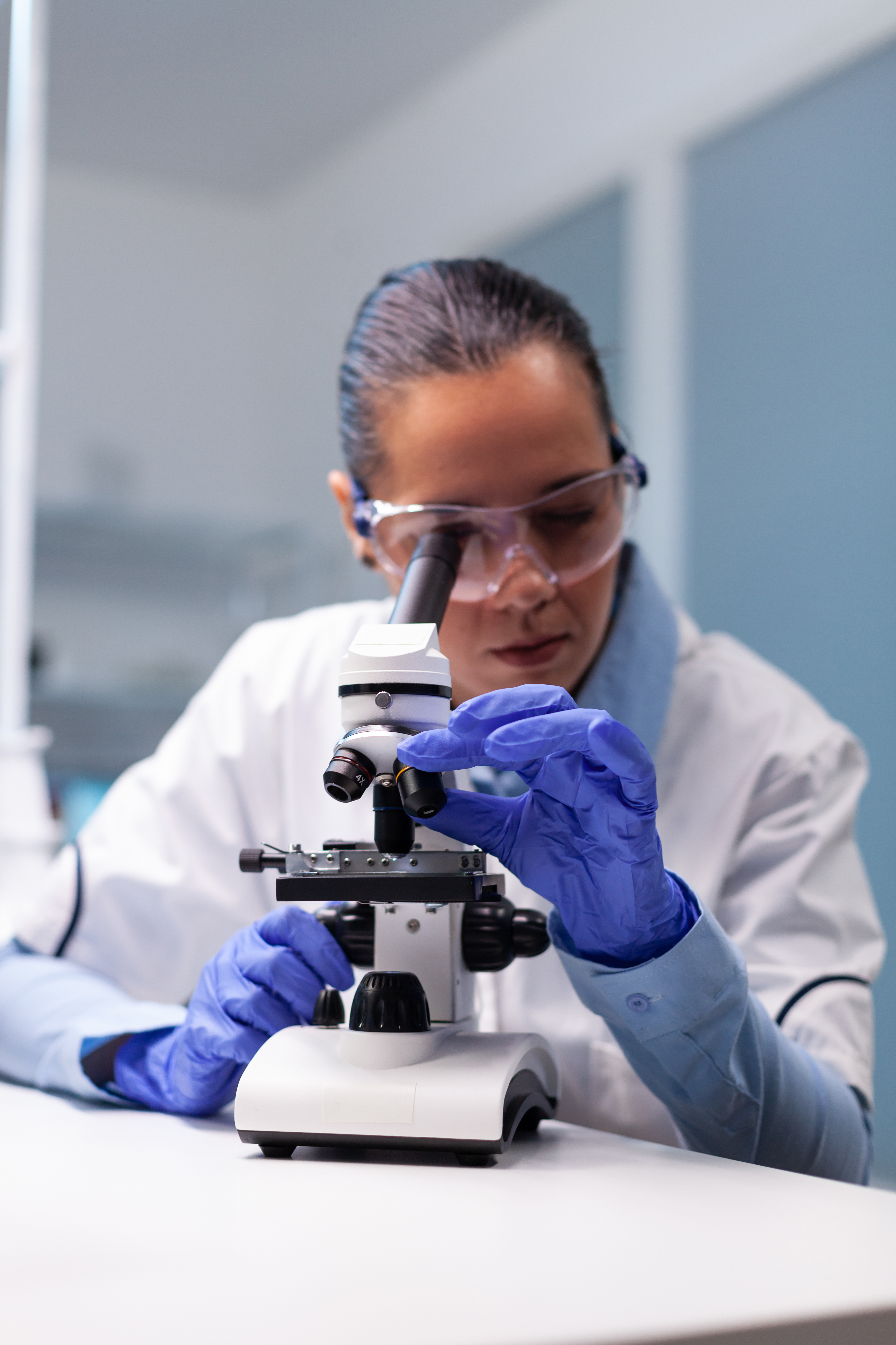 Specialist Pharmacist Examining Bacteriology Infection Lab Test Using Medical Microscope