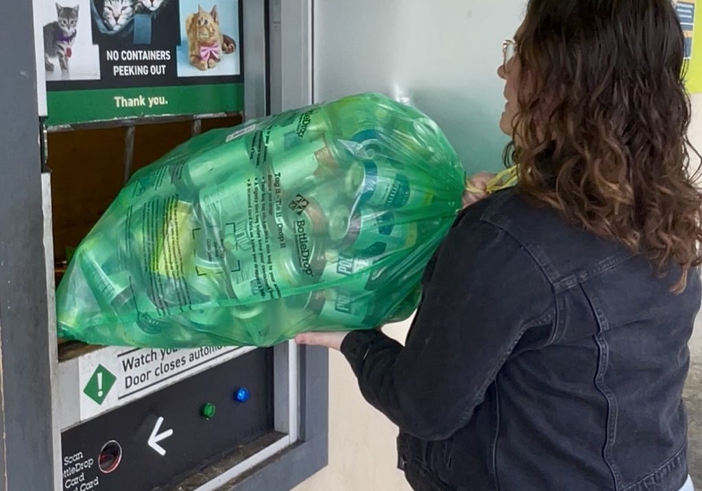 A person deposits bottles
